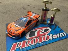 My Xray and its Invitational trophies!  I'm running an ORCA TX 17.5, Orion R10 Pro US Stock Spec ESC, Savox 1252 low-profile servo, Reedy 5500 60C lipo, Protoform Mazda Speed6 body, and Contact RC foam tires.  Controlled by a KO Propo EX1-KIY