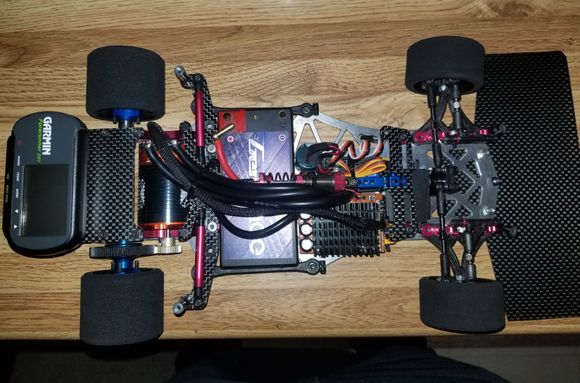 Looking closer you can see the R5.2 shock mount set up. It also allowed me to use a modified servo mount on one side to stabilize the taped servo. The nature of the TOP front suspension doesn't allow for the use of two servo mounts. 
I believe the rear hubs are also AE. 