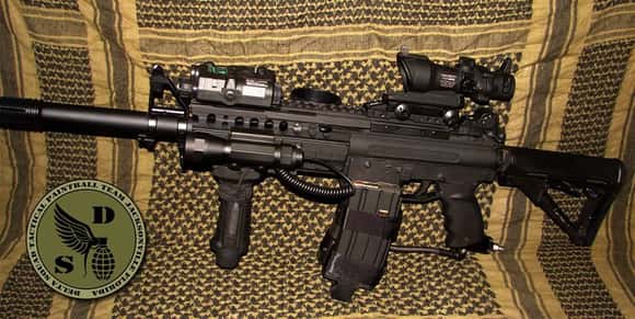 A tippmann A5, heavily modified to a customers suggestions. Even the clamp mag on the side had fake 5.56 bullets. The marker was based upon a real M4 SIR layout.