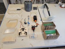 Everything was neatly organized on my worktable.  Some items, such as the door and window will also get fiberlassed.  Missing from the picture are the wing halves, which are ready for primer.