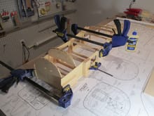 Once the left side dried, I glued on the right side.  Here I'm using my clamps across the fuselage.  All you need is a small amount of clamping pressure as too much will bow the formers.