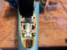 This set up works GREAT in service. However, after flying this aircraft at its first meet I found the moving it around by the tail is tricky. The tail is HEAVY and slips out of your had easily.  One time it dropped and broke the whole retract bulkhead loose!  Had to Hysol it back together at the meet!  Now I use a lanyard looped around the tail to drag it around.