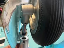 (I shortened my gear doors and haven't repainted yet)
This pic shows the BLIND ROLL PIN (!!) that hold this axle housing on the strut.  I could not believe my eyes when I saw this.  Ultimately I had to thread the center of the roll pin, install a 4-40 bolt and them beat the sh*t ou of the housing to get it to come out.  You'll see I redesigned it.