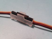 Just slide it in and hear the clip grab the top of your servo plugs to keep them together!