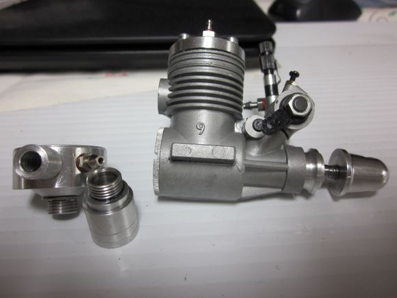 The middle part is the header for a pipe.  The left part is the stinger with the larger hole.  It is easier to just remove the stinger and drill a 6mm hole.  If your field allows it, no muffler is better yet.