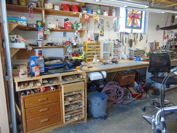I salvaged an old computer desk for its draws. The draws and film covering section are 24" deep. The rest is 36" deep. The wood shelf's slide in dadoes.
This was an upper kitchen cabinet.  The cabinet on the other end was a bottom unit. Can't see it well in these pictures.
