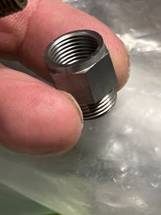 12mm female on the other.

Adds one muffler thread length to the pipe.