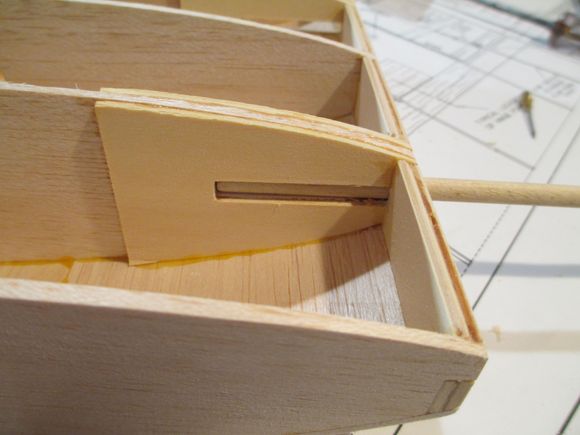 This photos shows how the dowel is held in alignment with the slots.  Don't be tempted at this point to epoxy the dowels in now as they will only later get in your way if you are going to cover your model.