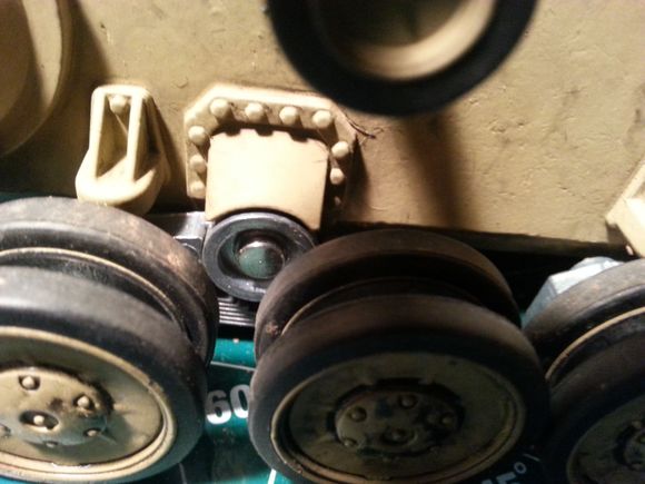 How do you get this round fastener off (so that you can remove the suspension arm)?