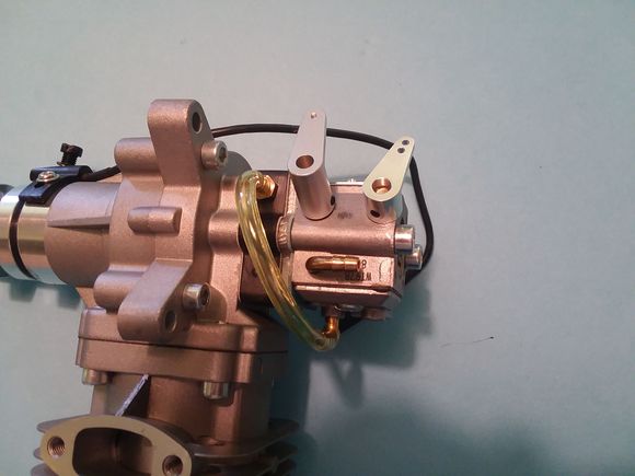 No drilling needed.  Fit all of the brass shafts from a Walbro Carb.  the different heights keep the push rods away from each other when installed.