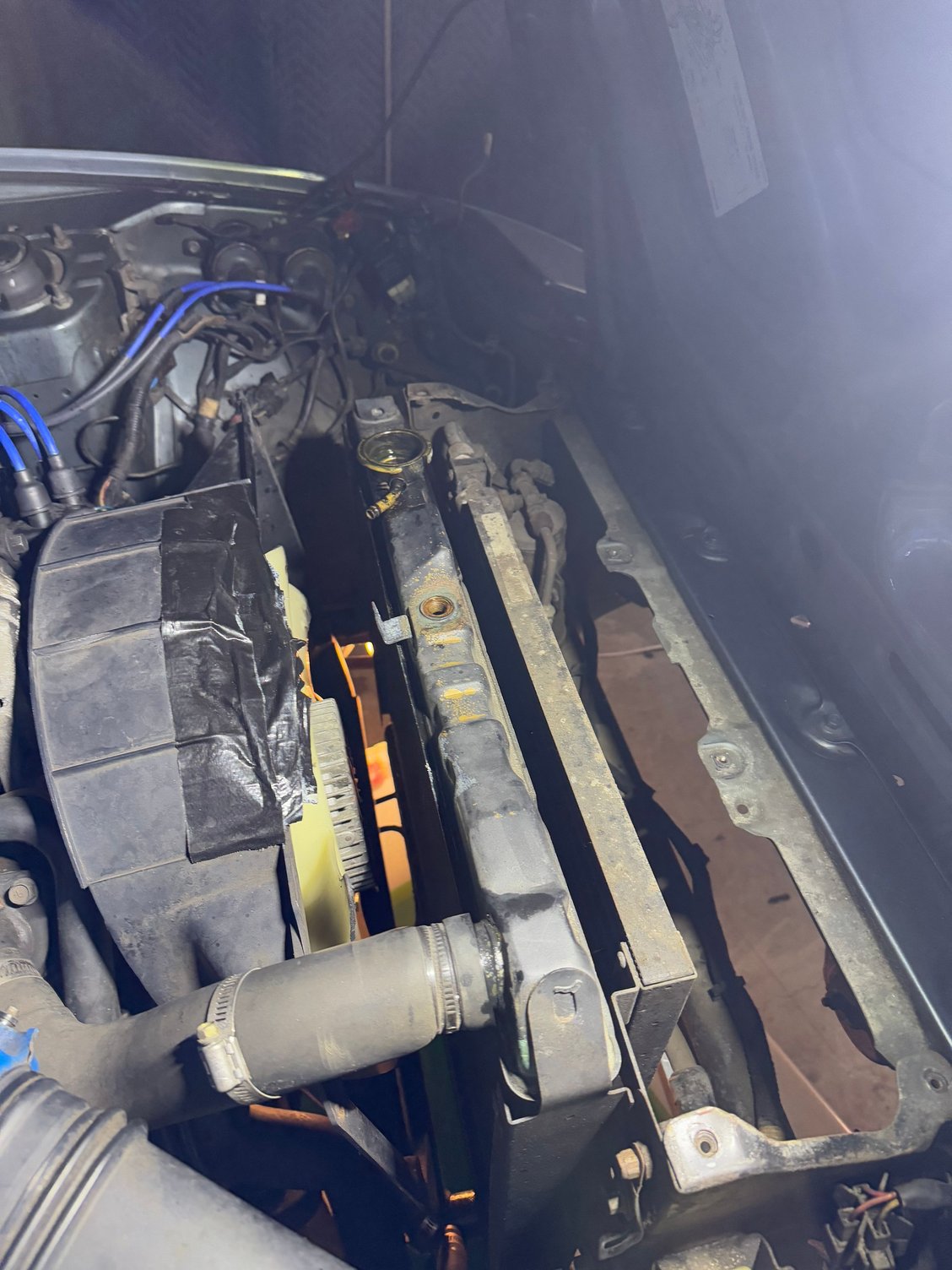 Take off all the sensors and wires and hoses off the top of the radiator.