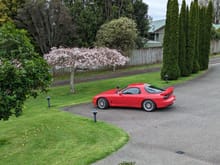 Far away view of my RX7 with a cherry tree in bloom.  Very Japan.