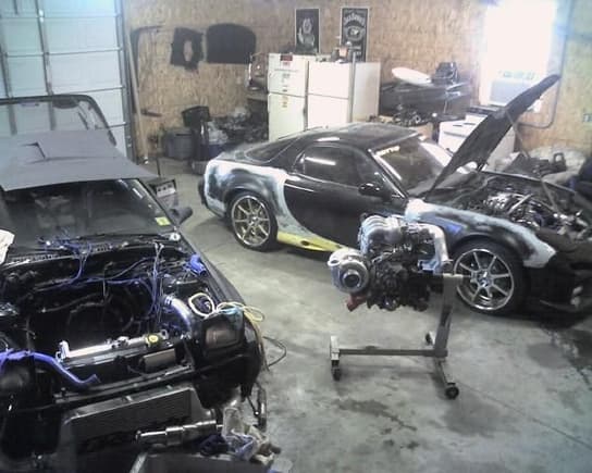 Asshole's Garage. The 3rd gen has a HX50 w/ a half bridge, and yes thats a Cosmo w/ a 4088 hanging off it ready to go into the 2nd gen. We build our own motors. Phil has experience w/ all 3 gens, RX-8, and the RE in the pic. Let me know if you need a rebuild, he's very capable.