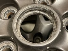 Old rim with a recessed area in the center where the center cap clips go