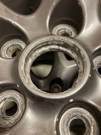 Old rim with a recessed area in the center where the center cap clips go