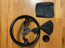 Original steering wheel, boot cover, console cover, and also a oil filter wrench.
