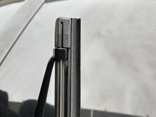 If you look, you'll see the inboard-most tab (or the outboard-most tab on the passenger-side arm) locks into place into the rubber insert.