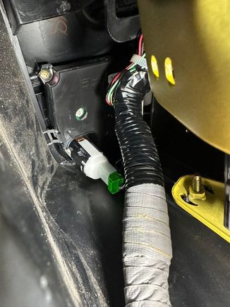 You'll have to contort yourself to get a good view but the goal to the squeeze the metal, gold-ish colored table on the side of the button. You can see it just peeking out from the fascia. You can either squeeze it hard or put a thin plastic tool into the tab. It is the only thing keeping the Start button connected to the dash. 