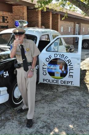 Old D'iberville police car with old D'iberville police officer.