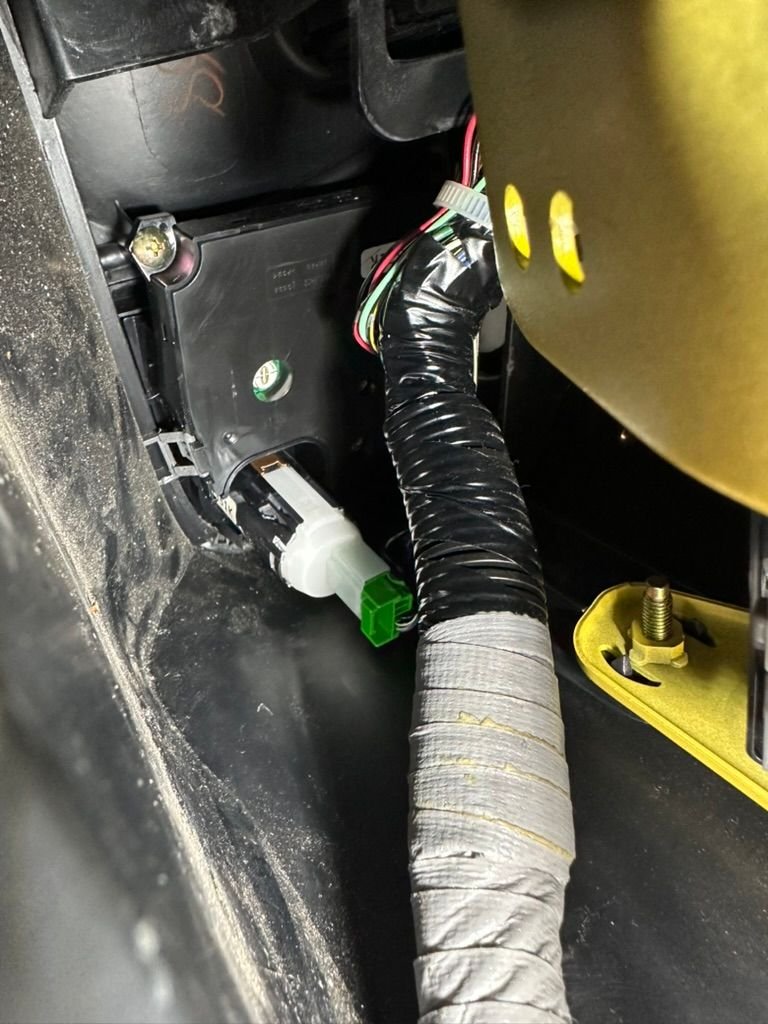 You'll have to contort yourself to get a good view but the goal to the squeeze the metal, gold-ish colored table on the side of the button. You can see it just peeking out from the fascia. You can either squeeze it hard or put a thin plastic tool into the tab. It is the only thing keeping the Start button connected to the dash. 