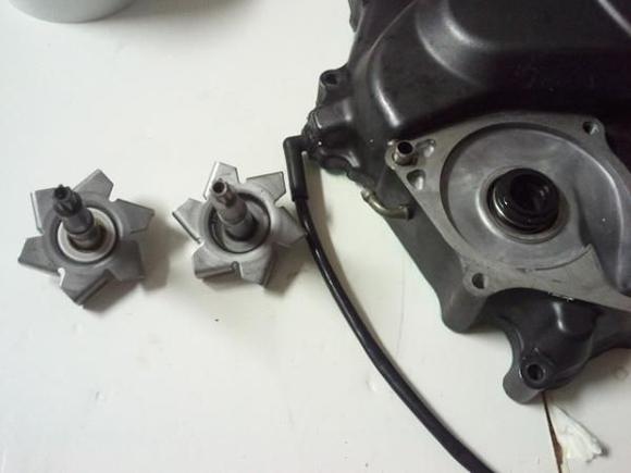 The old worn impeller is on the left and the one I just took out is on the right. The dealer forgot to put the white ceramic ring on the new impeller.