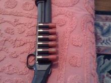 I made some modifications to my father's Mossberg... I added an ammo rack to the receiver, an a surefire fore-end.
