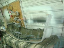 Bumper cover upside down on the bench to start repairs.