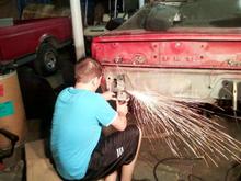 Rear bumper mounting holes/plate was rusted out. Cut out the body panel with the high speed cut off, fabed up a new piece and welded it in, and there i am grinding down the excess weld.