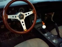 Wood steering wheel, white shifter knob, old skool console clock, need I say more?