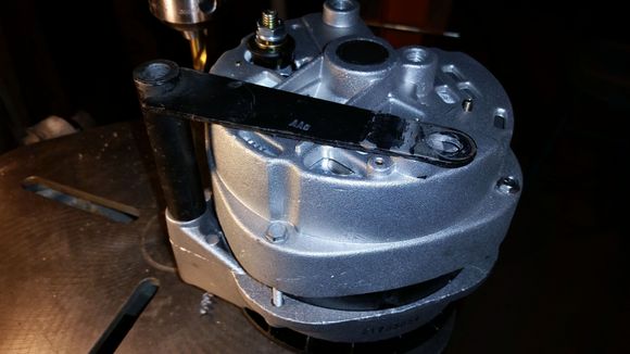 I was going to machine a nice aluminum spacer for the pivot bolt but noticed that the stock spacer/bracket might work if it was straight.  I threw it in my 40 ton press and flattened it- it's really close.