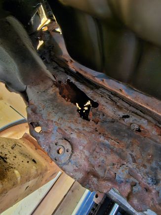 Found a pocket of rust after pulling the pan out.  Did realize that in the passenger side and drivers side there is a hole for water to get in between the outer shell and the inner on the rocker panel.  This was a mess.  I cut this out and cleaned it up.