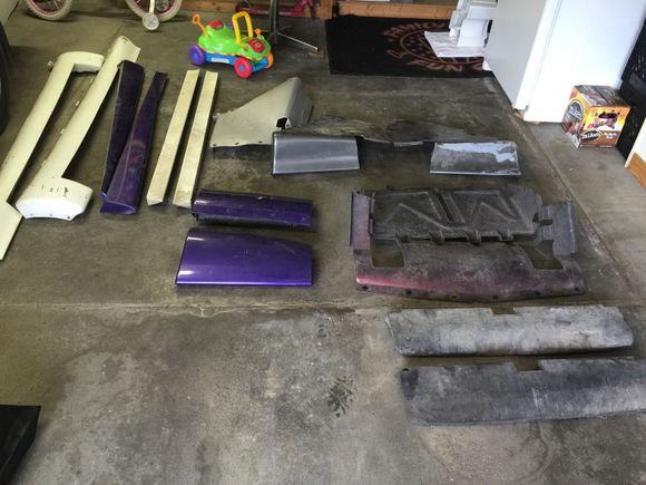 Everything on the right came off of an 88 GTA. 
Far left two white ones and all purple came off of a 91 transam. Help me figure out if I've got a whole set of ground effects or not. I've got the back bumper from the 91 but not the gfx for the rear.