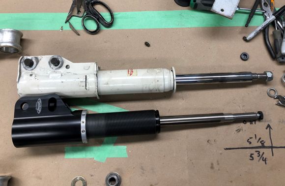 the shock body 'threads' into the spindle mount to allow height adjustment