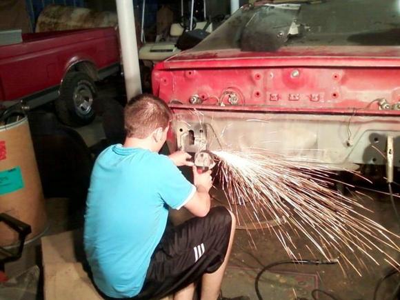 Rear bumper mounting holes/plate was rusted out. Cut out the body panel with the high speed cut off, fabed up a new piece and welded it in, and there i am grinding down the excess weld.