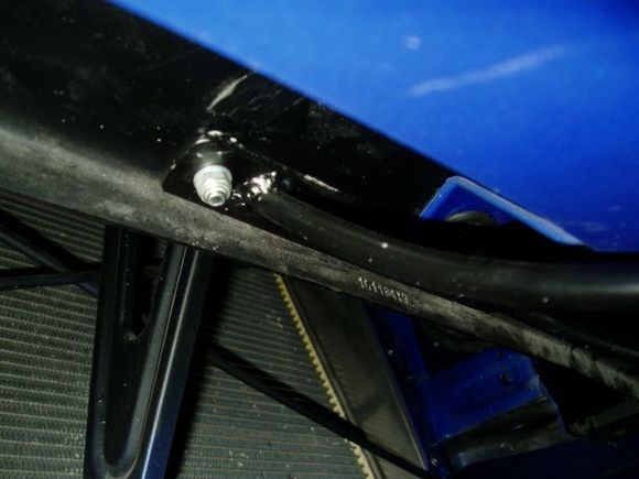 Sorry, this is the only picture I could find of the actual license plate mount.  Or at least some of it...