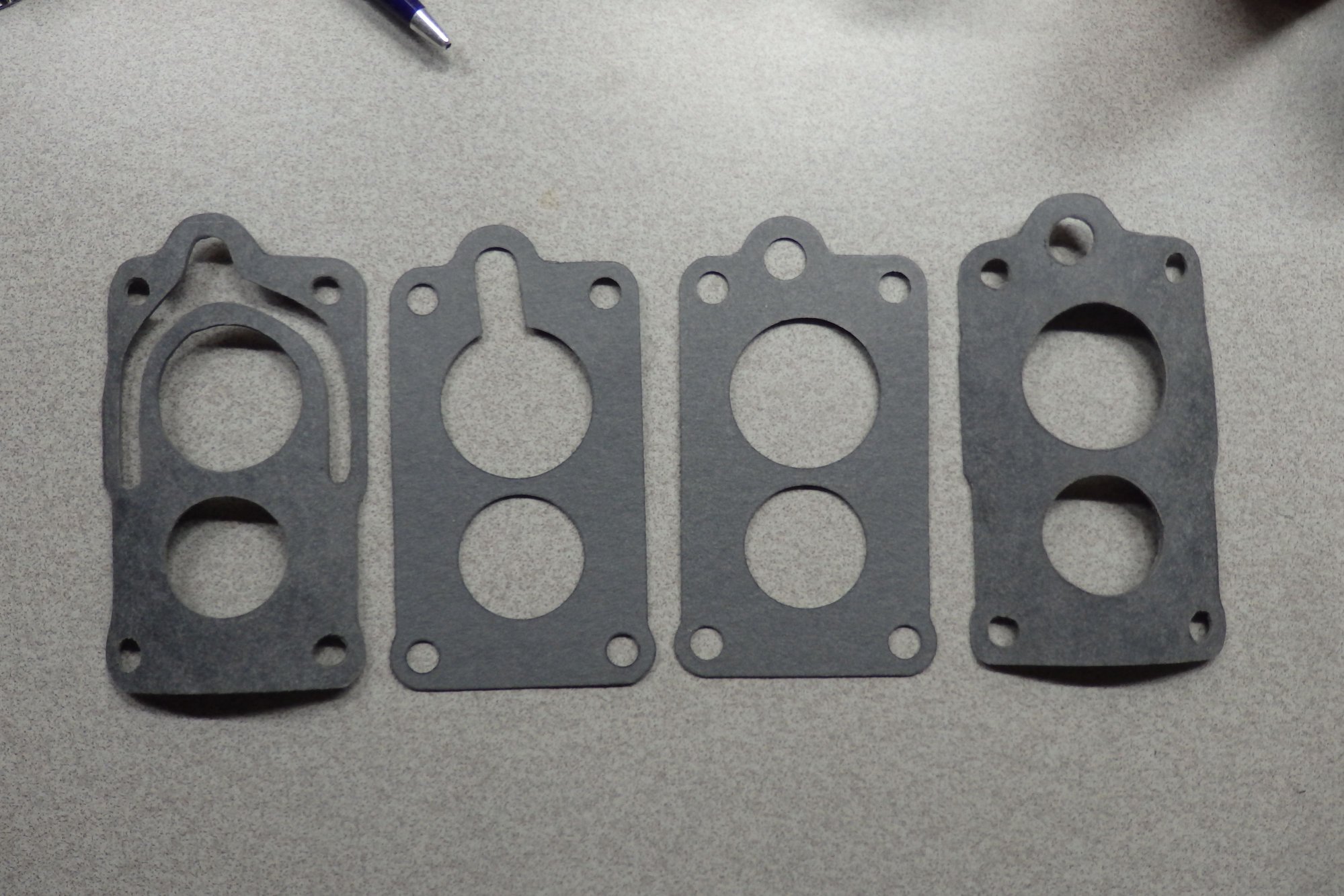 Gaskets I made, as compared to gaskets supplied by carburetor rebuilder.
