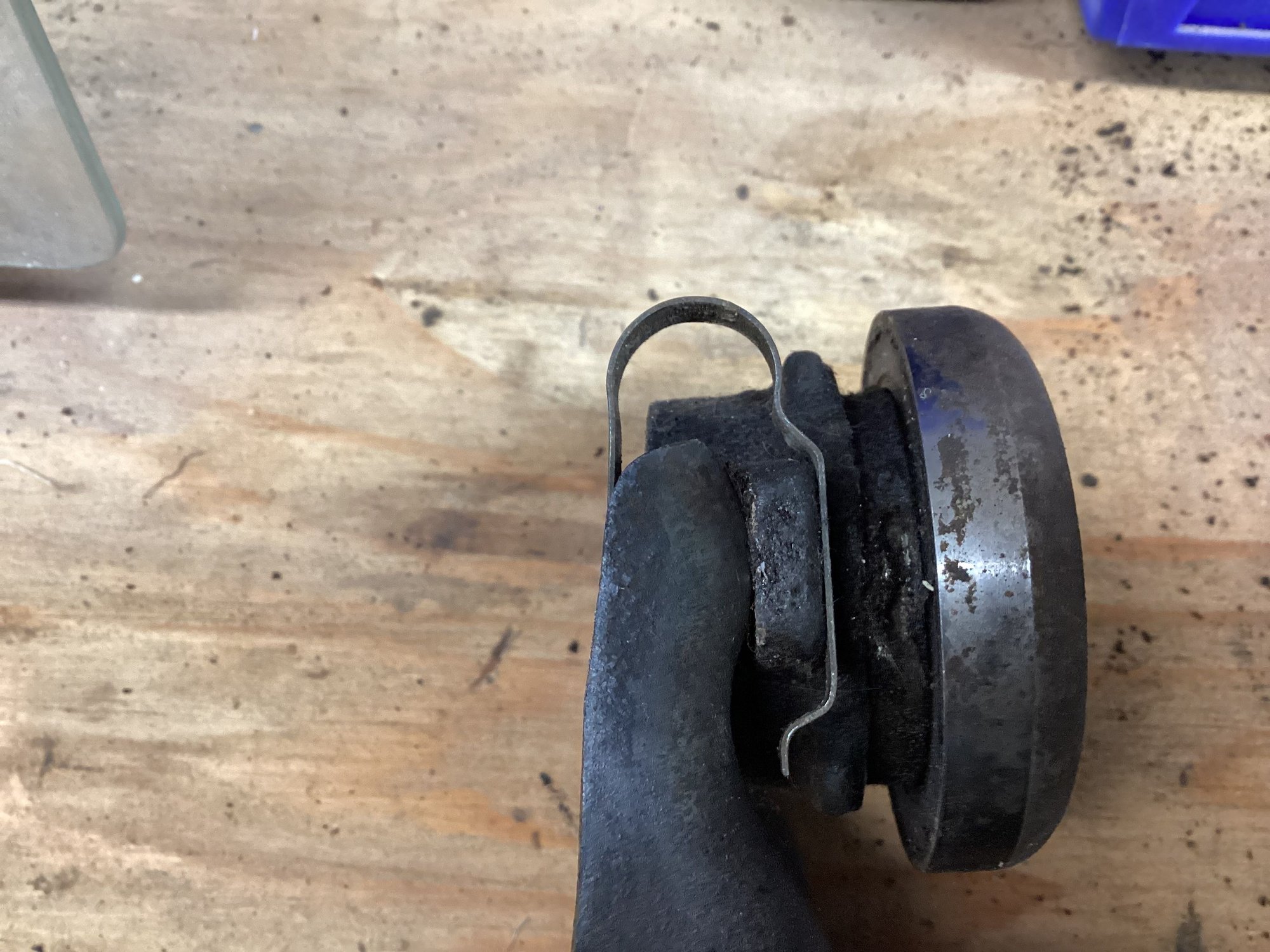 Top view with the back of clutch fork on the left side. The clips have a curly q on one end which fits into a depression in the back side of the fork while the other end wraps around the ear on the clutch collar holding that in place. The clutch bearing (on the right hand side in this pic) is pressed onto the collar with the round face of the bearing facing the engine. 