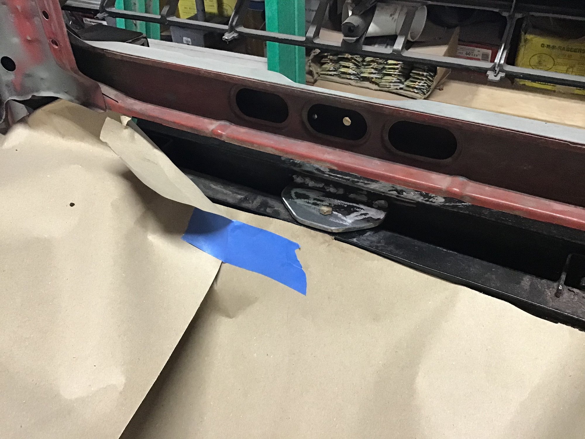 View from engine compartment looking at rear mounting bolt and tab. 