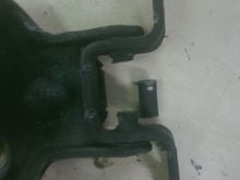 center section of the pin cut out to allow me to pound the heck out of it with a punch slightly easier.  When using a punch and hammer to get what little short sections of the pin are left out of it, be careful not to distort / bend the bracket out of shape too badly (vise helps a lot)