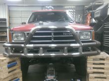 looks ready for some zombies.  I didn't have the right jacks to get the bumper at the exact height and level, so I put it on these blocks and lifted the front end of the rig up so it was in place.  For the final weld up when tacking on the winch plate and other supports, I think I'm going to hang it from an overhead gantry with the now infamous red ratcheting straps so I can get the whole thing perfectly level and square to the vehicle (jacking up the front end threw off the angle).