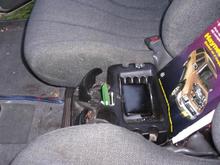 hump riding between seat low profile cup holder..yes it clears the shift knob with room to spare