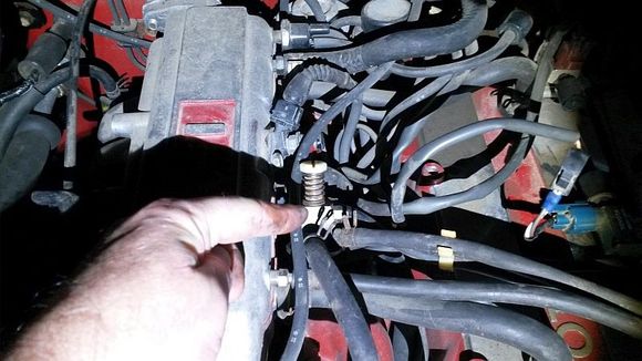 this is the idle adjustment valve if its working when the VSV is activeated it allows more air into the engine bypassing the throtlle plate causing a controled increase in engine rpms which keeps the AC compressor on as it will cycle off at normal idle rpms but not around 1K rpms the white adjuster is how you adjust the AC idle and also works with the power steering if its loading the engine