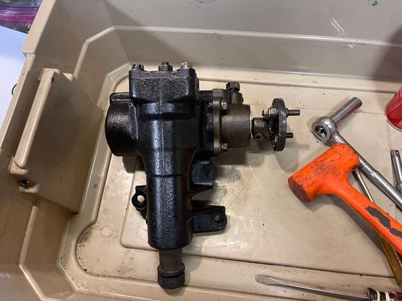 Working in a clean, shallow tub helps control the mess and parts. No special tools other than a pair of snap ring pliers.