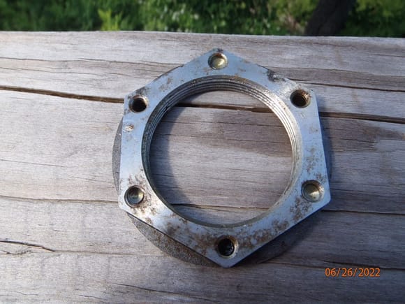 the 54mm wheel bearing retainer.  this is the side that faces out.  the torx screws attach to three of the holes, with an unused hole between each.  