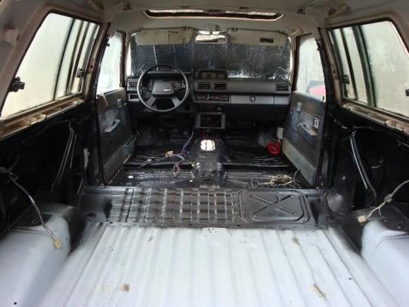 The inside all cleaned, painted and almost done applying bed liner.