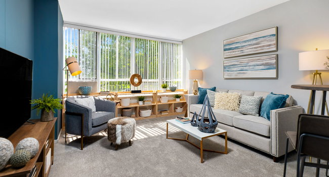 You&#39;ll find plenty of space to stretch-out, relax and enjoy the park views in this living room in our 1-Bedroom&#160;Alden floor plan.