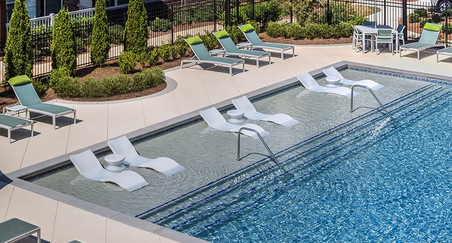 Resort-style pool with sun shelf and ample loungers